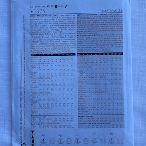 May include: A white paper sewing pattern envelope for Vogue V7975, featuring technical illustrations of five jacket variations labeled A through E. The back of the envelope displays detailed sizing charts, fabric requirements, and notions in English.
