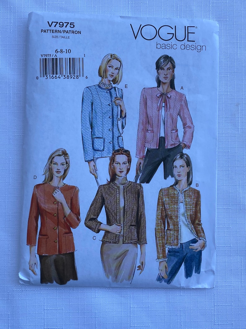 May include: A Vogue basic design sewing pattern envelope labeled V7975 for sizes 6-8-10. The front features illustrations of five different jacket styles labeled A, B, C, D, and E, showcasing various textures, colors, and front closures including buttons and ties.