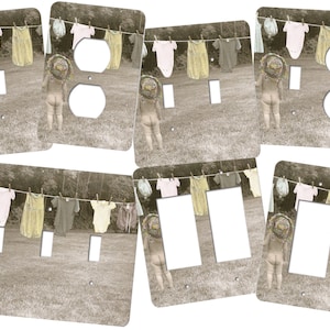 May include: A set of six light switch and outlet covers featuring a vintage photograph of a child standing in front of a clothesline with baby clothes hanging on it. The child is wearing a sun hat and is facing away from the camera. The background is a sepia-toned image of a grassy field and trees.