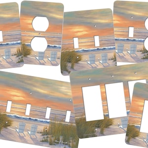 May include: A set of four light switch and outlet covers featuring a beach scene with a sunset, white chairs, and seagrass. The covers are available in single, double, and triple switch configurations.