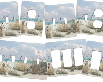 This beach switch plate cover features a gorgeous view of the sand, sea grasses, sailboats, great blue heron and ocean sky.. SS205