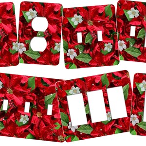 May include: Set of six light switch and outlet covers featuring a red poinsettia floral pattern. The covers are white with a glossy finish.