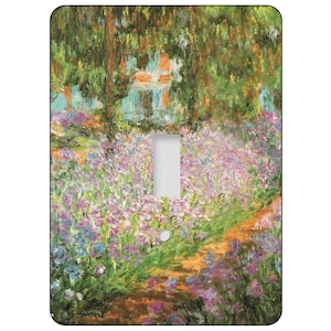 May include: A decorative light switch cover featuring a colorful impressionist painting of a garden with purple and blue flowers, green foliage, and a path. The artwork has a textured, painterly style, with a focus on light and color.