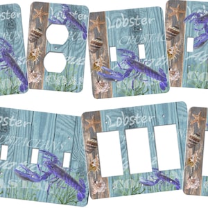 May include: A set of four light switch and outlet covers featuring a blue lobster, seashells, and starfish on a light blue woodgrain background. The text "Lobster Crustaceans" is written on the covers.