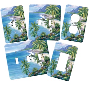 May include: Set of five tropical beach scene light switch and outlet covers. The covers feature a blue ocean, white sandy beach, palm trees, and lush green foliage. The covers are available in a variety of sizes to fit standard light switches and outlets.