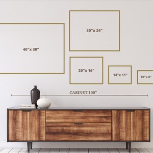 May include: A wooden cabinet with a dark finish, featuring two drawers and doors, is positioned below a series of framed art pieces. The frames are in varying sizes, including 40" x 30", 30" x 24", 20" x 16", 14" x 11", and 10" x 8". The text "CABINET 100" is also present.