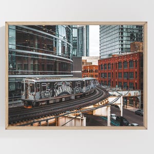 May include: A framed print featuring a train with "Jack Daniel's" branding traveling on elevated tracks through a city. The image showcases the train's design and the surrounding architecture, including brick buildings and modern skyscrapers.