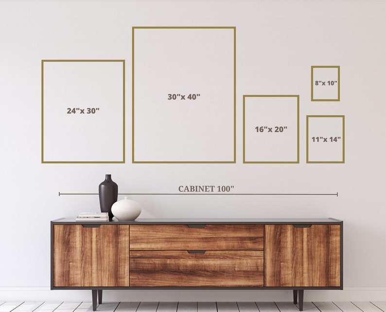 May include: A wooden cabinet with a dark finish, holding decorative vases and books. Above the cabinet are framed art pieces in various sizes, including 24" x 30", 30" x 40", 16" x 20", 11" x 14", and 8" x 10". The word "CABINET 100" is also visible.