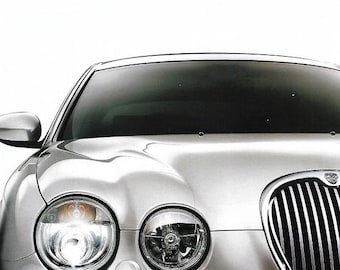 May include: A silver Jaguar S-Type car with a chrome grill and round headlights. The image includes the text "THE NEW S-TYPE" and "The art of performance | JAGUAR". The car's design is sleek and modern.