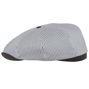 May include: A gray and black striped newsboy cap with a black brim.