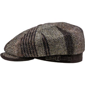 May include: A brown and grey tweed newsboy cap with a dark brown suede brim and a buckle detail. The cap has a classic, paneled design with a textured appearance, suitable for autumn and winter wear.