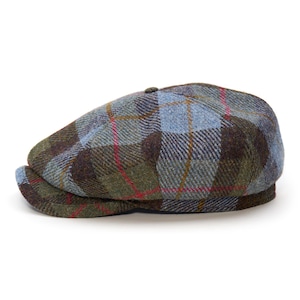 May include: A tweed flat cap with a traditional design. The cap displays a plaid pattern in blue, green, brown, and red. It has a curved brim and a button detail. This hat is a fashionable accessory.