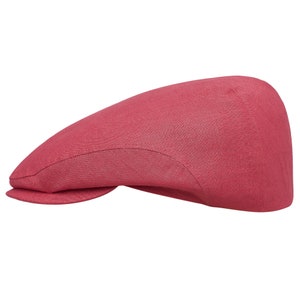 May include: A red linen newsboy cap with a curved brim.