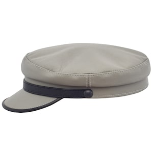May include: A grey leather sailor cap with a black leather band and a black button.