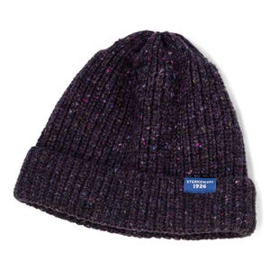 May include: A dark purple knit beanie with a ribbed design. The hat has flecks of color throughout and a small blue tag that reads "STERKOWSKI 1926". This winter hat is a warm accessory.