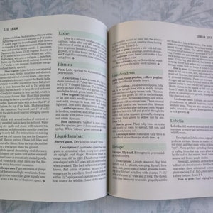 May include: A close-up of a book page with text about different types of plants, including Lime, Linum, Liquidambar, Liriope, and Lobelia. The text describes the plants' characteristics, how to grow them, and their landscape uses.