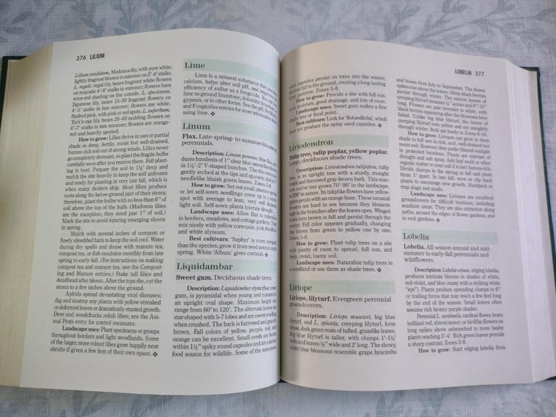 May include: A close-up of a book page with text about different types of plants, including Lime, Linum, Liquidambar, Liriope, and Lobelia. The text describes the plants' characteristics, how to grow them, and their landscape uses.