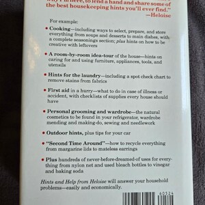 May include: A vintage paperback book titled "Hints and Help from Heloise." The cover features a list of household tips, including cooking, laundry, and first aid. The book's ISBN is 0-517-60524-4.