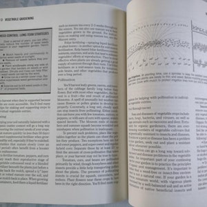 May include: A close-up of a page from a gardening book with a section on weed control, long-term strategies, and a section on fertilizing. The text discusses using mulch, windbreaks, and cover crops to control weeds. It also mentions the importance of keeping soil naturally balanced with good organic matter.
