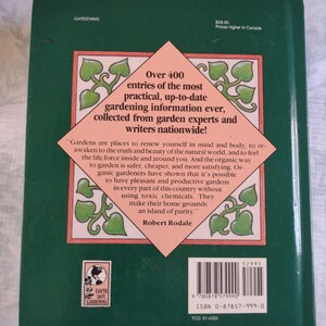 May include: A green book cover with a pink and green illustration of a garden. The book title is "Earth Safe Gardening" and the text on the cover reads "Over 400 entries of the most practical, up-to-date gardening information ever, collected from garden experts and writers nationwide!"