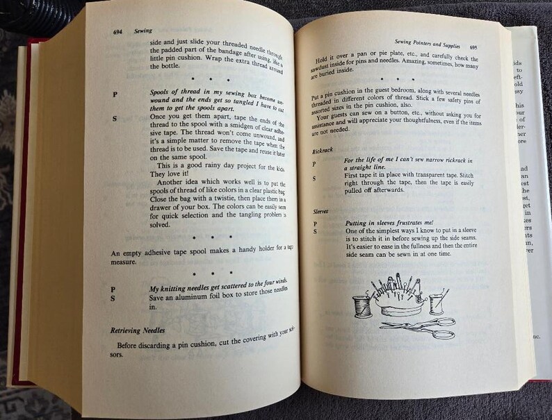 May include: Open book with text and illustrations about sewing. The left page has text about spools of thread and knitting needles. The right page has text about sewing pins and sleeves, with illustrations of sewing tools.