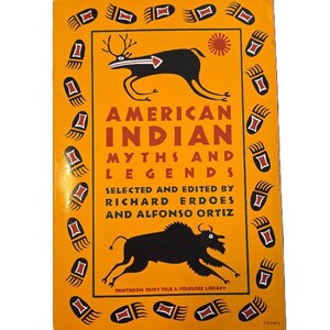 May include: A vintage book titled "American Indian Myths and Legends" with a bright orange cover. The cover features black illustrations of a deer and a bison, along with decorative paw prints and text. The book is part of the Pantheon Fairy Tale & Folklore Library.
