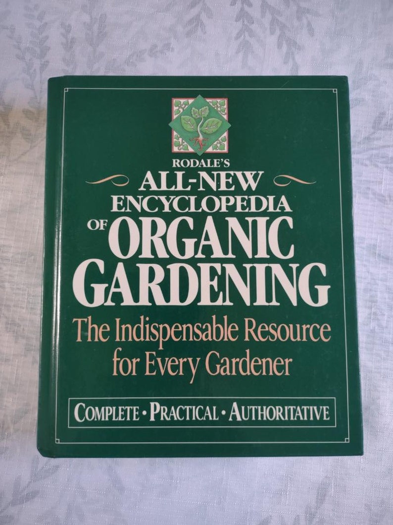 May include: A green book titled "Rodale's All-New Encyclopedia of Organic Gardening" with the subtitle "The Indispensable Resource for Every Gardener" and the words "Complete Practical Authoritative" at the bottom.