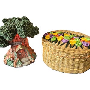 May include: A miniature treehouse with a sign that reads "Welcome" and a wicker basket with colorful flowers around the top.