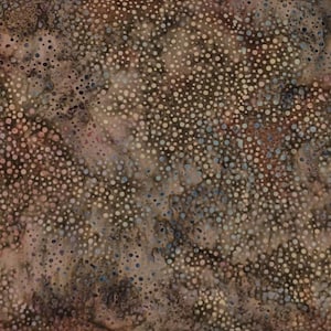 May include: A fabric with a mottled pattern featuring small, irregular white, blue, and brown dots. The background has a mottled appearance with shades of brown, tan, and hints of pink, creating a textured effect.