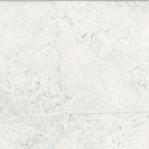 May include: A textured, off-white fabric with subtle blue-gray markings. The surface appears to be divided into rectangular sections, with faint lines suggesting seams or folds. The overall effect is a muted, slightly aged appearance.