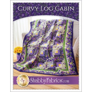 May include: A floral quilt with a "Curvy Log Cabin" design, featuring squares of purple, white, and yellow. The quilt has a dark purple border with floral accents and a green stripe. The Shabby Fabrics logo is visible at the bottom.