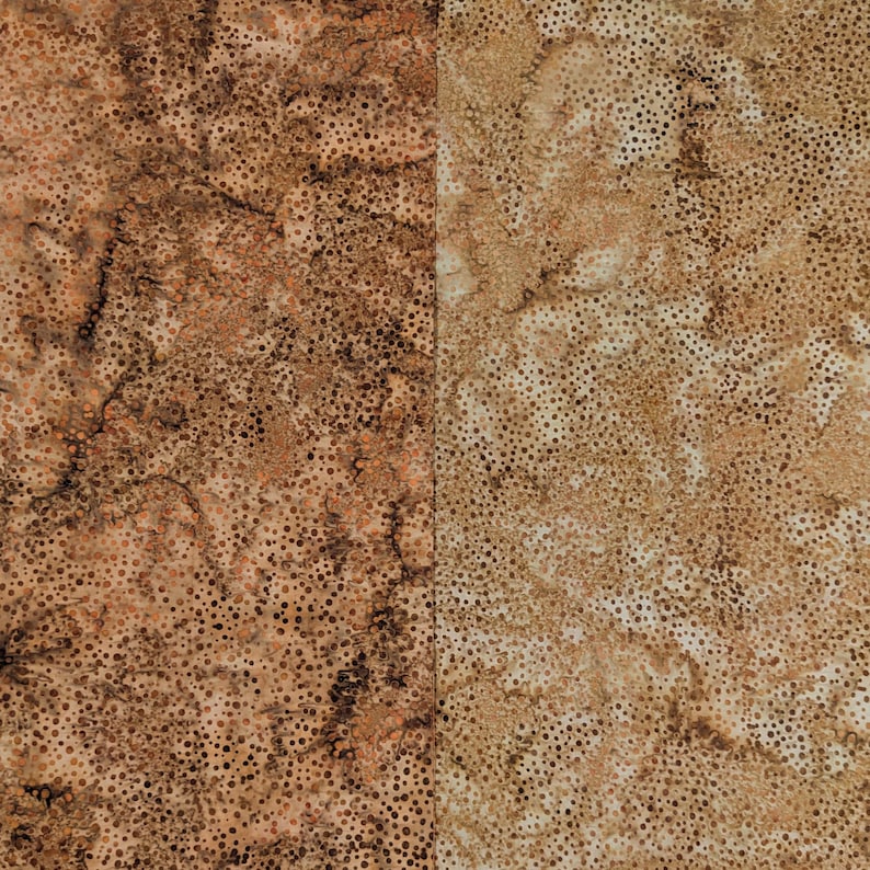 May include: Two-panel fabric with a mottled pattern. The left panel is primarily brown with darker brown spots and veins. The right panel is tan with brown spots. The fabric has a textured appearance.