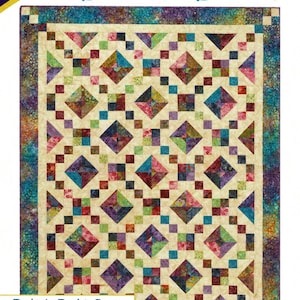 May include: A quilt pattern titled "Buckeye Beauty" by Cozy Quilt Designs. The quilt features a geometric design with diamonds and squares in shades of teal, purple, pink, and green. The pattern includes sizes for throw, long throw, queen, and king quilts.