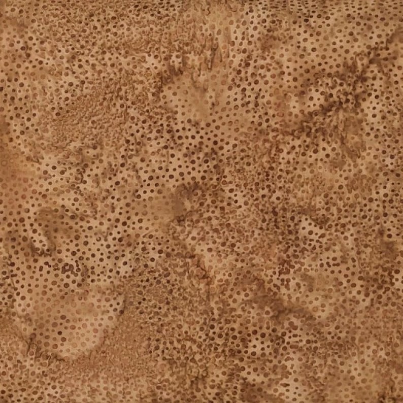 May include: A close-up of a brown fabric with a mottled appearance. The fabric has a pattern of small, evenly spaced dots in varying shades of brown, creating a textured effect. The overall color palette is warm and earthy.