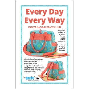 May include: A teal diaper bag-backpack-purse with a floral pattern and coral accents. Features padded handles, backpack straps, and an adjustable shoulder strap. Includes a changing pad. Text reads "Every Day Every Way" and "byannie.com".