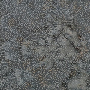 May include: A fabric with a mottled pattern of small, white and tan dots on a dark gray background. The design has a batik-like appearance, with subtle variations in color and texture.