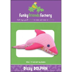 May include: A pink and magenta soft toy dolphin, 17 inches long, with a patterned body and solid fins. The packaging features the text "funky friends factory" and "Dizzy DOLPHIN". The dolphin has a button eye.