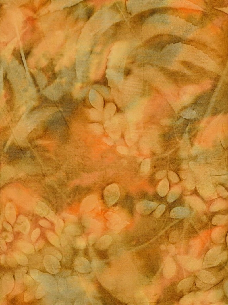May include: Textile artwork in warm tones. The design incorporates orange, brown, and beige, with leaf-like patterns and organic shapes. The fabric appears textured, possibly made from natural fibres. The overall effect is of a natural, earthy aesthetic.