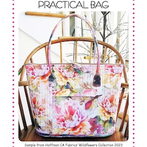 May include: A floral print tote bag with a quilted design. The bag features a large, colorful flower pattern in pink, yellow, and white. The bag is 16 inches wide, 6 inches deep, and 14 inches tall. The text on the bag reads "Aunties Two Patterns".