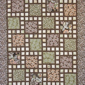 May include: A handmade quilt with a grid pattern. The quilt features squares of floral fabric in shades of green, peach, and brown, set against a brown grid. The border is a floral pattern on a brown background. A cozy, decorative textile.