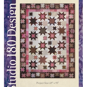 May include: A quilt pattern titled "Yankee Pride" featuring a star design in shades of brown, pink, and cream. The project size is 69" x 93". The pattern is by Deb Tucker for Studio 180 Design.