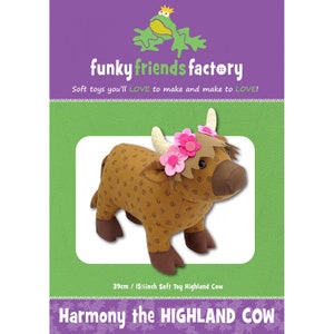 May include: A soft toy Highland cow, featuring brown fabric with a spiral pattern, brown legs, and cream-colored horns. The cow wears a pink flower crown. The packaging reads "funky friends factory" and "Harmony the HIGHLAND COW". The toy is 15 inches long.