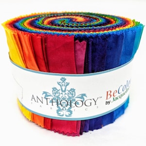 May include: A roll of colorful fabric strips in a rainbow of hues, from yellow to blue. The fabric is wrapped with a white label that reads "ANTHOLOGY FABRICS" and "BeColor by Jacqueline". Ideal for quilting and crafting projects.