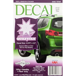 May include: A white Quilt Star vinyl window decal on a purple background, with the text "DECAL" in green. The decal is 4.875" x 5.5" and is white on clear die-cut vinyl backing. The image also shows a green car.