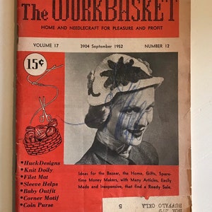 May include: Vintage "The Workbasket" magazine cover from September 1952, featuring a woman wearing a hat. The cover is red with black text, including "Home and Needlecraft for Pleasure and Profit." It lists craft projects like Huck Designs and Knit Doily.