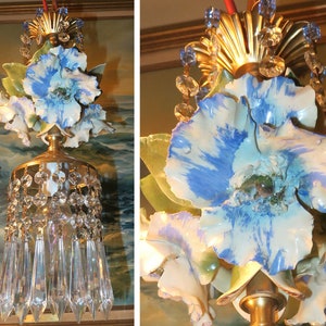 May include: A vintage chandelier with a floral design. The chandelier features porcelain flowers with blue and white paint, and crystal drops.