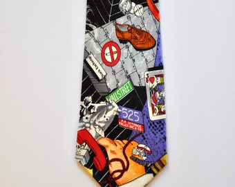 May include: A black silk tie with a colorful pattern featuring a phone, a shoe, a playing card, and the words "Stock Exchange" and "Wall Street".
