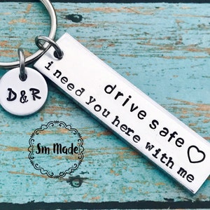 May include: Silver keychain with a charm that says "D&R" and a rectangular tag that says "drive safe I need you here with me" with a heart symbol.