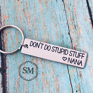 May include: Silver keychain with a rectangular tag that reads "DON'T DO STUPID STUFF ♥ NANA".