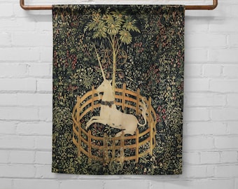 May include: A tapestry featuring a white unicorn trapped in a circular fence, surrounded by a lush green forest with flowers and foliage. The unicorn's horn is pointed upwards, and its tail is flowing behind it.